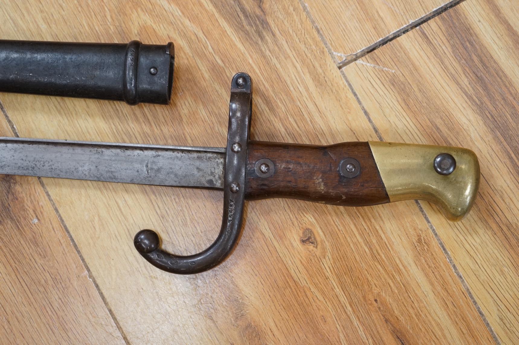 Three bayonets; a gras bayonet, a Lebel bayonet and an Indian Enfield style triangular socket bayonet, all in the original scabbards